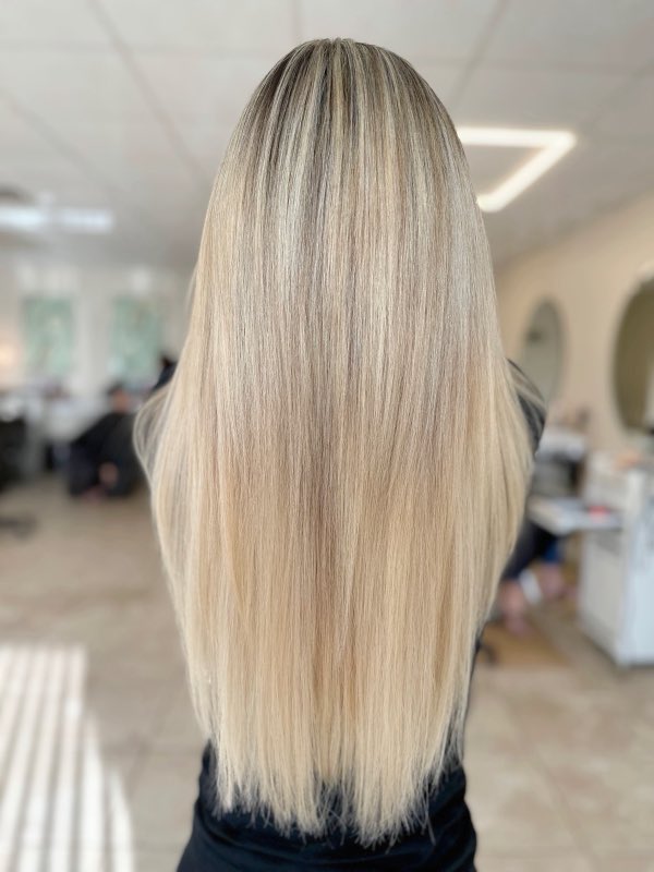 Long, sleek blonde balayage in the salon